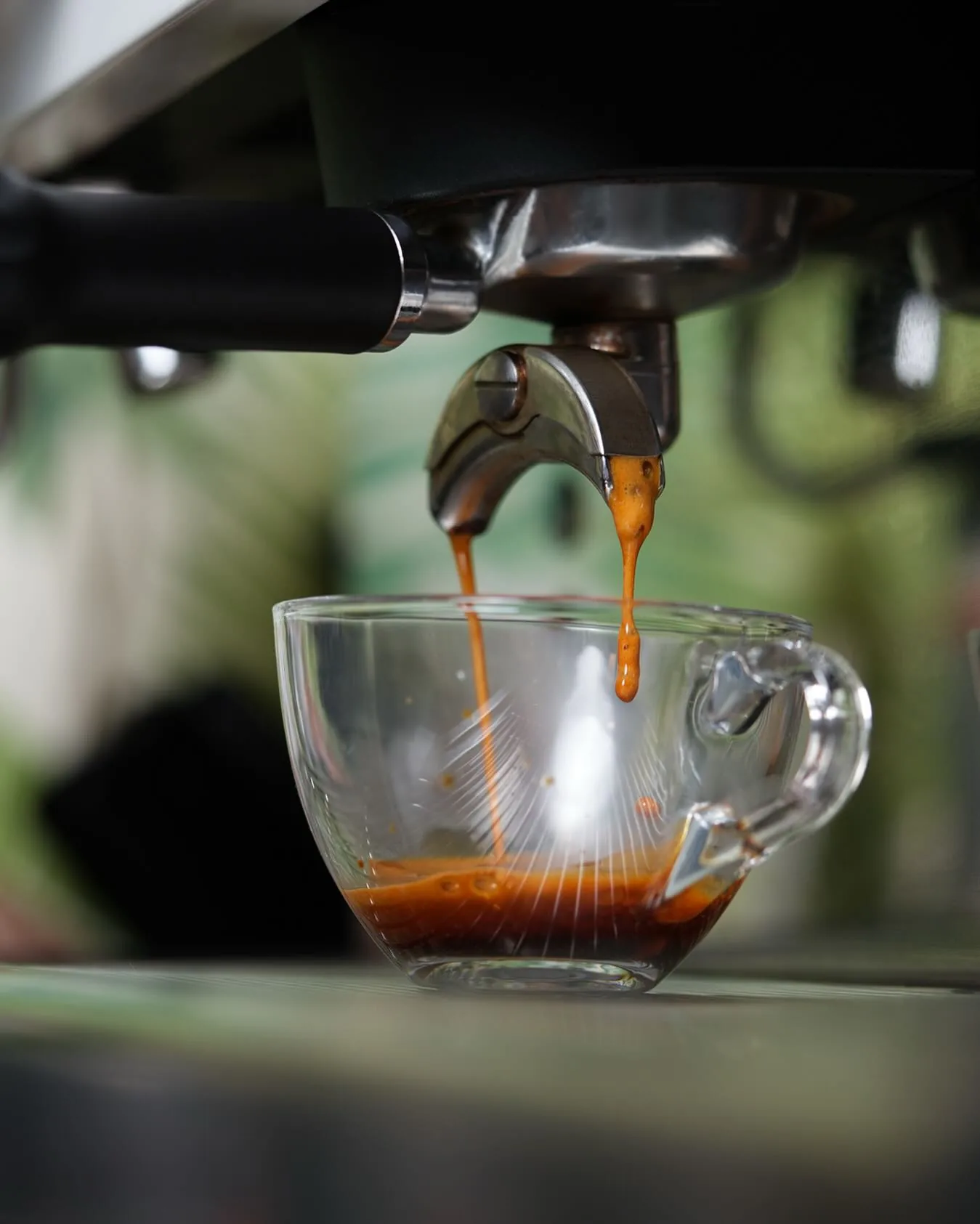 Espresso dripping into a glass cup