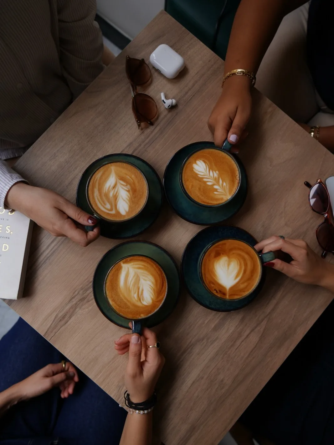 Four friends, four lattes, seen from above