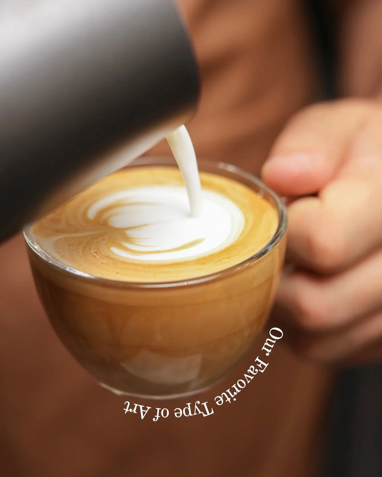 Milk poured into a latte, a rosetta forming