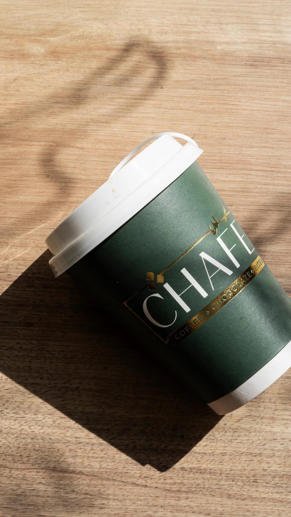 The green CHAFÉ takeaway cup