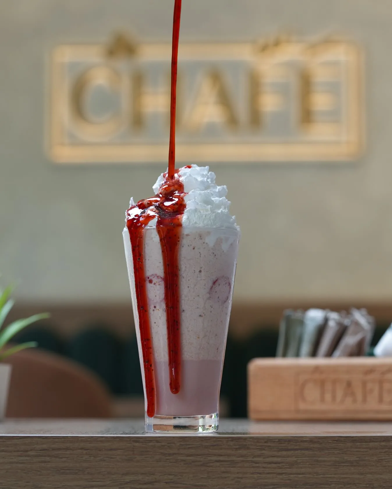 A berry frappé under a drizzle of coulis